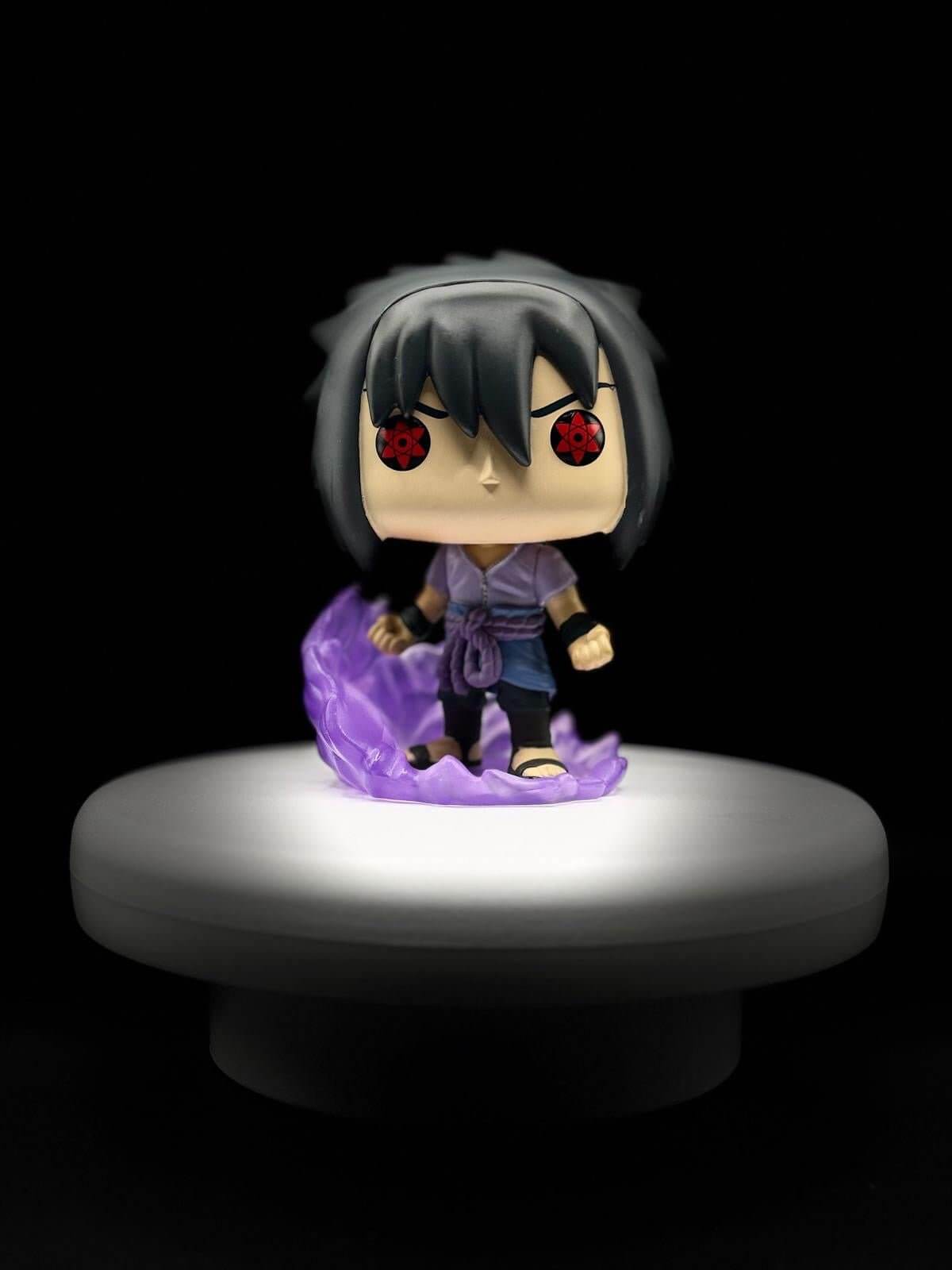 Funko Pop! Sasuke Uchiha figure with purple flames, showcasing detailed design from Naruto Shippuden animation.